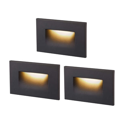 Cloudy Bay Three dark bronze rectangular LED step lights glowing warm, product shot on white background