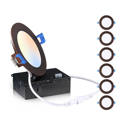 Oil rubbed bronze gimbal recessed light lit warm white, shown with junction box and cables on a white background